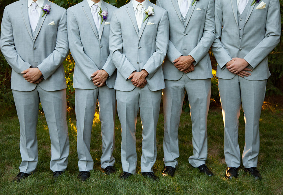 Groomsmen and groom from the shoulder down showing their formal wear