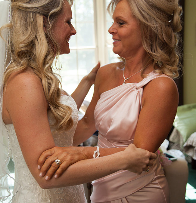 Bride and her momsharing a moment before her wedding in Valley Forge, PA